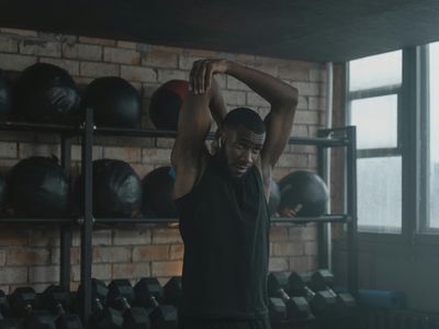 Man stretching his arms before a workout session.