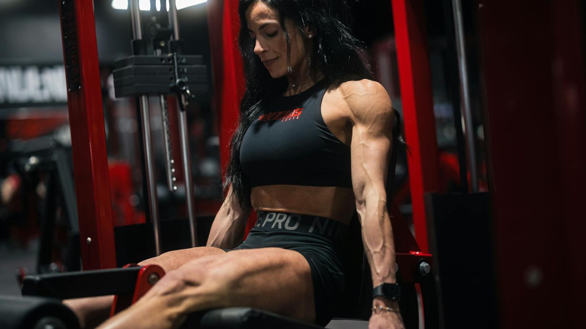 Professional athlete performing strength exercises in a modern gym.