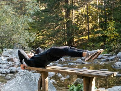 Shadow of a man doing pull ups on a bar.